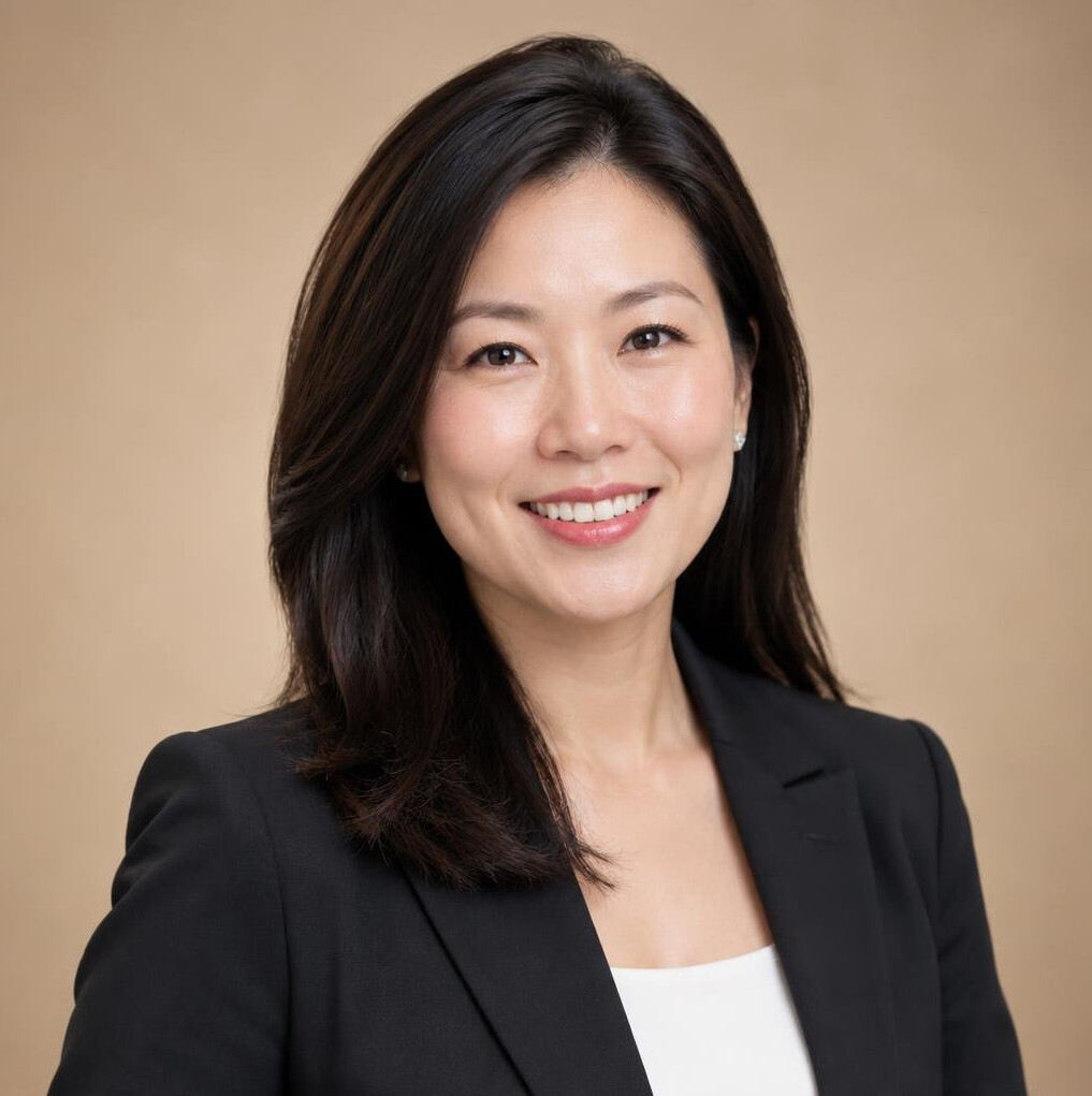 Studio portrait of a Singaporean Chinese woman in business attire smiling