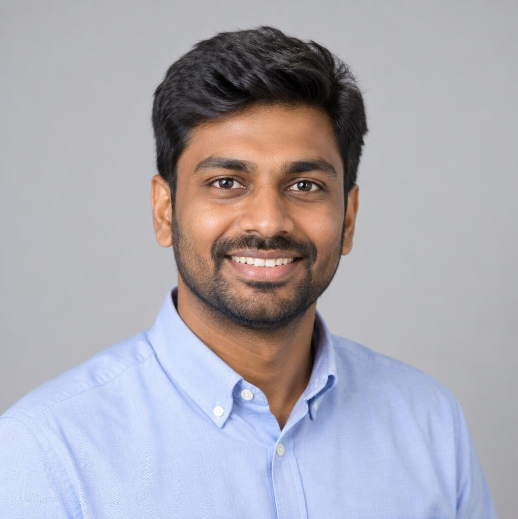 Studio portrait of a Singaporean Indian man in business casual attire smiling